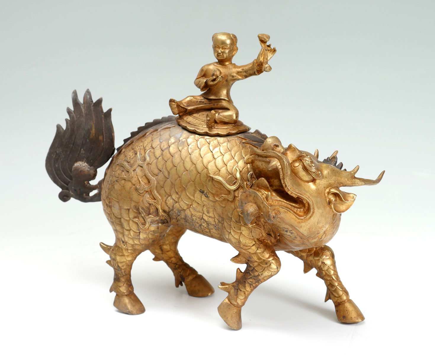 Appraisal: CHINESE GILT BRONZE CHI-LIN WITH YOUNG WARRIOR Chinese Gilt bronze