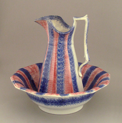 Appraisal: Blue and red rainbow spatter pitcher and bowl th c