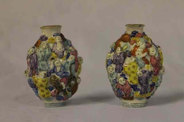 Appraisal: A PAIR OF CHINESE PORCELAIN SNUFF BOTTLES each with raised