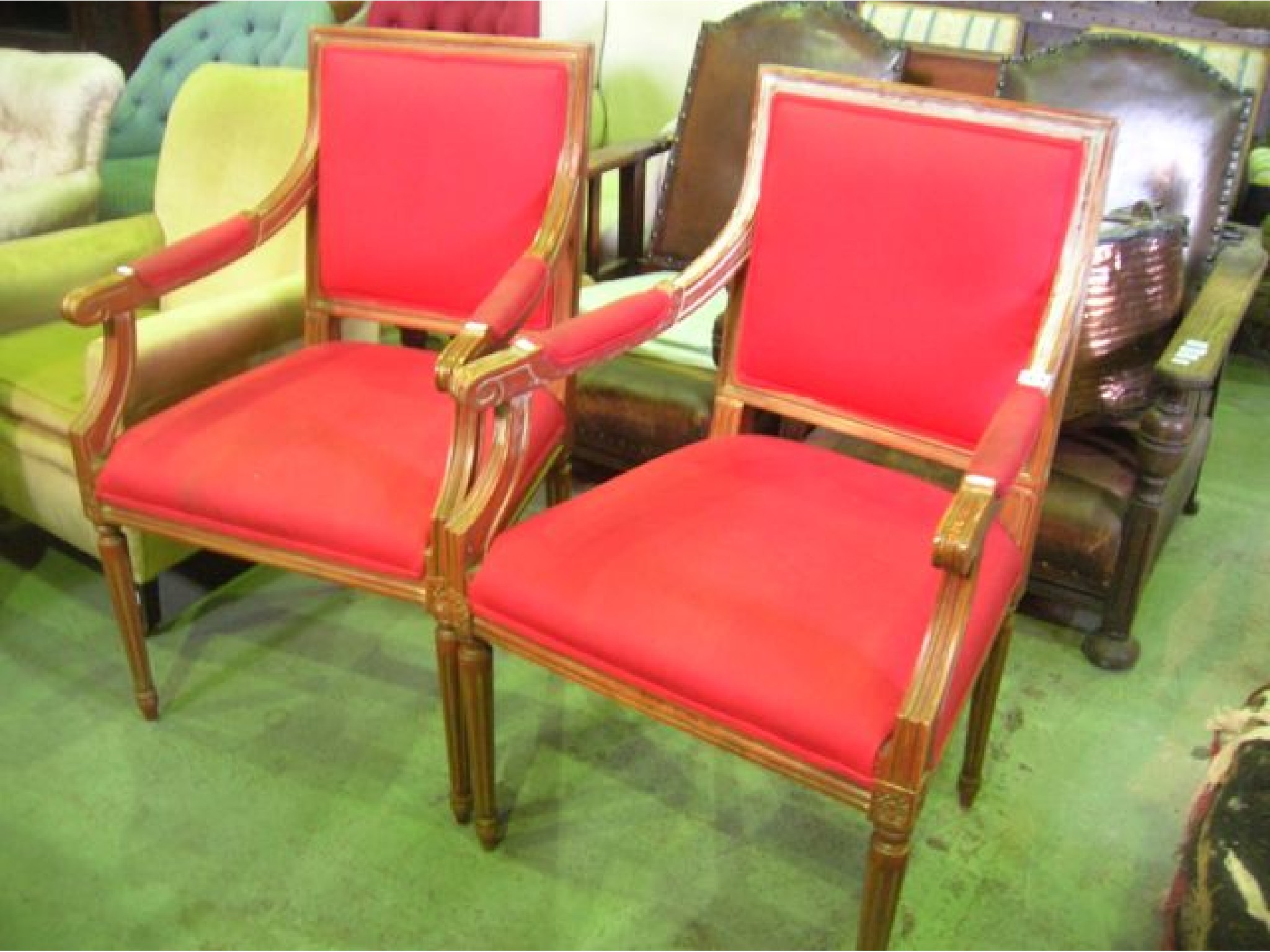 Appraisal: A pair of open armchairs with upholstered seats back pads