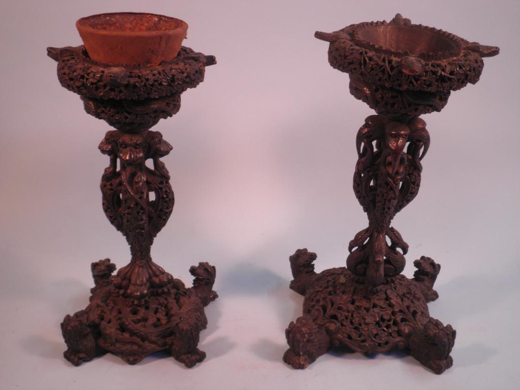 Appraisal: Two Burmese carved hardwood stands each decorated with serpents birds