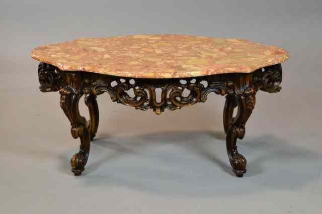 Appraisal: FRENCH MARBLED TOP WALNUT TABLEThe heavily carved walnut base carved