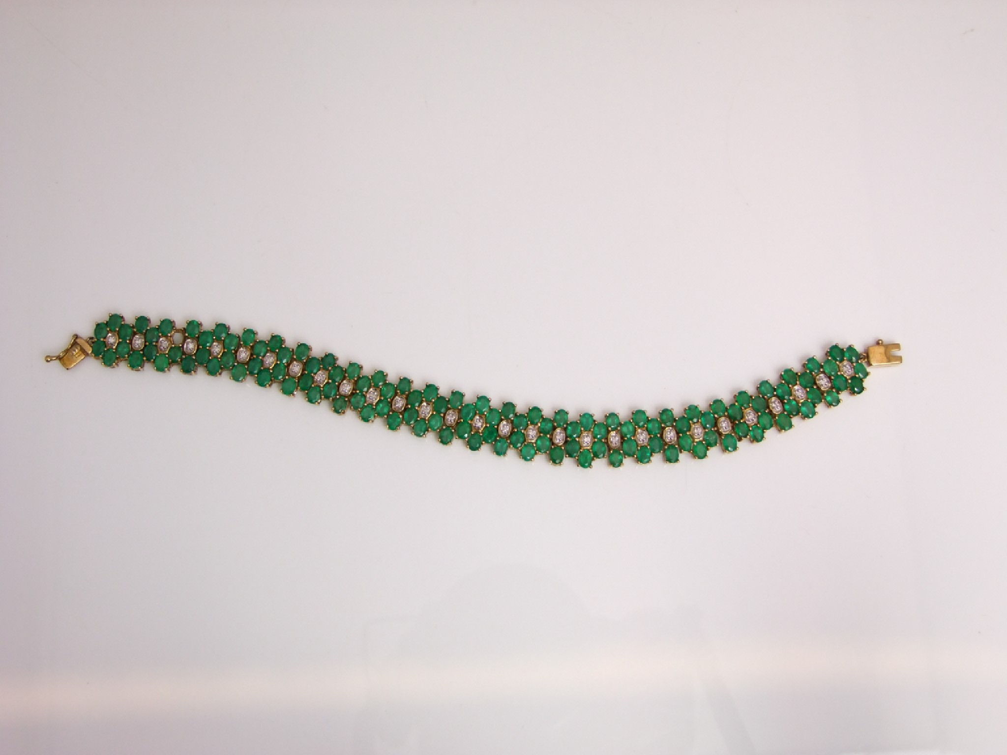 Appraisal: An emerald and diamond bracelet Rocks Co set with one-hundred