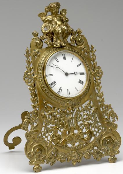 Appraisal: FRENCH DRESSER CLOCK In brass ornamented with cupids with easel