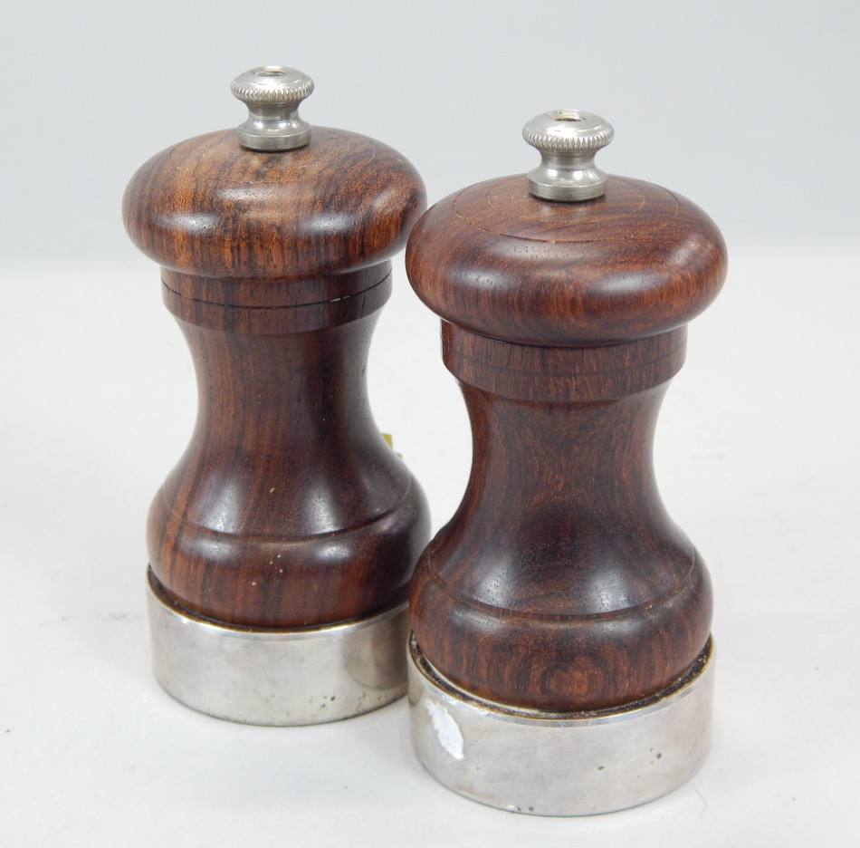 Appraisal: A turned hardwood and silver mounted pepper and sugar grinder