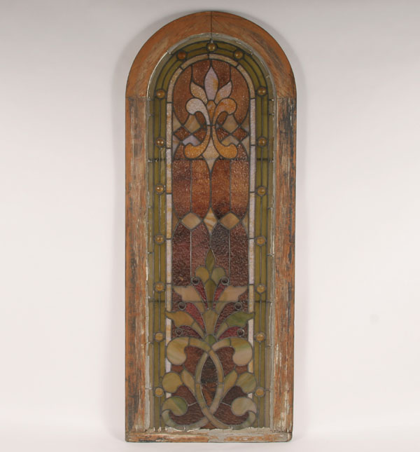 Appraisal: Leaded stained glass window with arched top composed of multi-colored