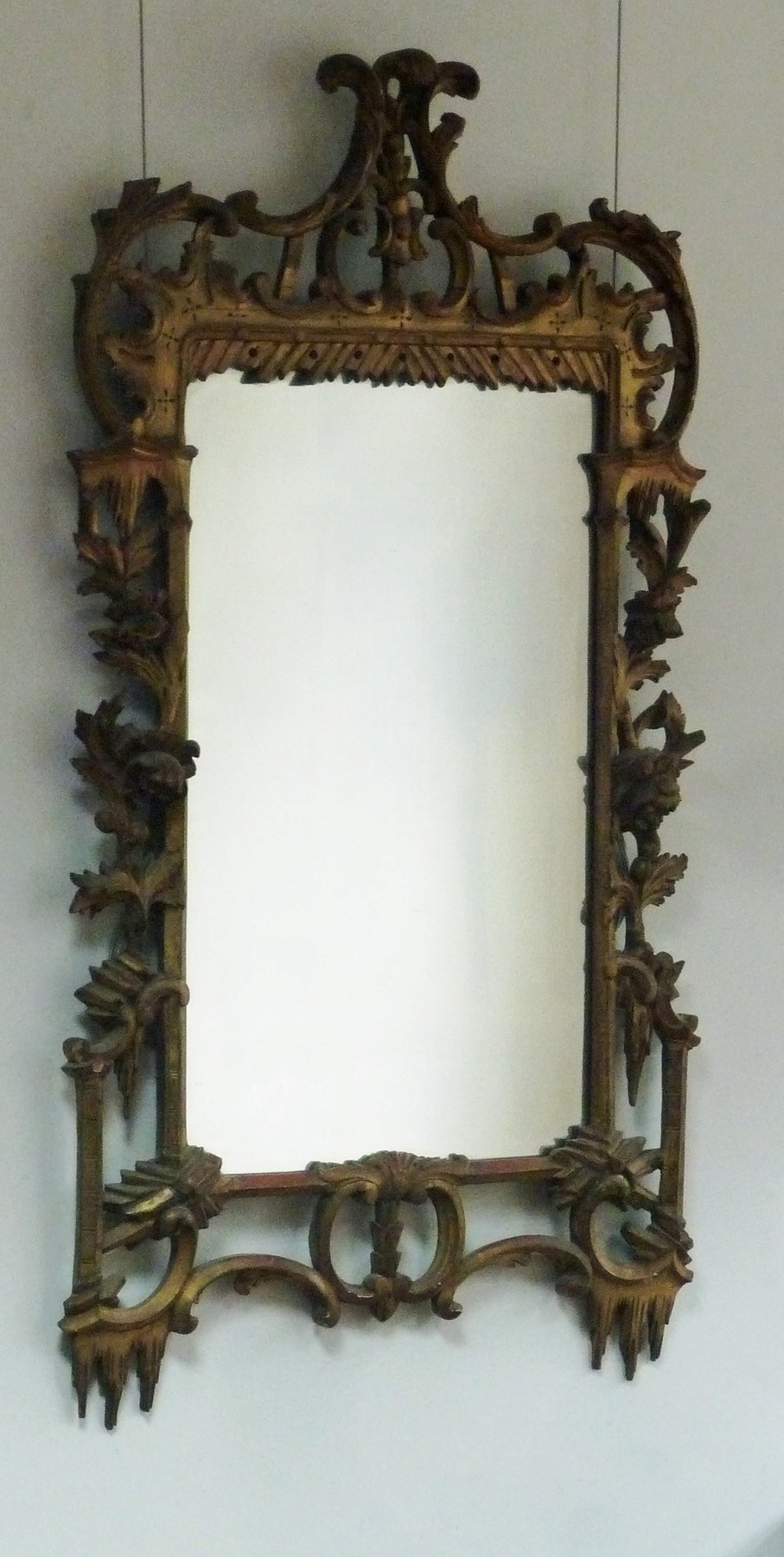 Appraisal: A George III carved and gilded wall mirror carved with