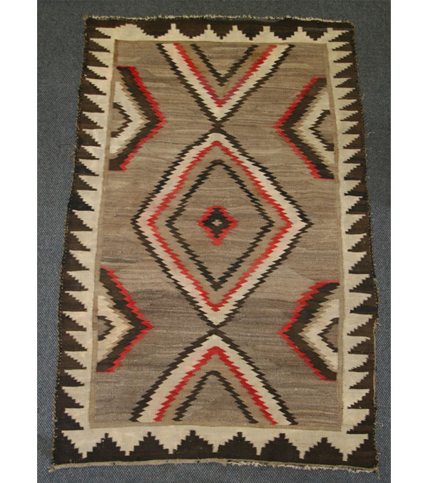 Appraisal: Navajo woven wool rug with central diamond design x Some