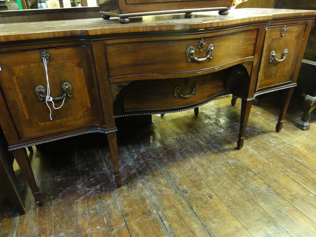 Appraisal: A Georgian mahogany sideboard with serpentine front fitted with two