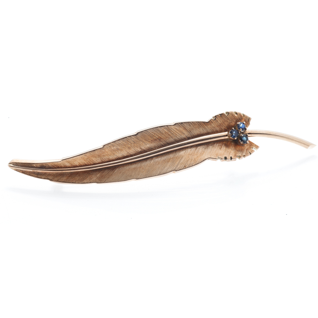 Appraisal: A sapphire set feather brooch modelled in unmarked yellow metal