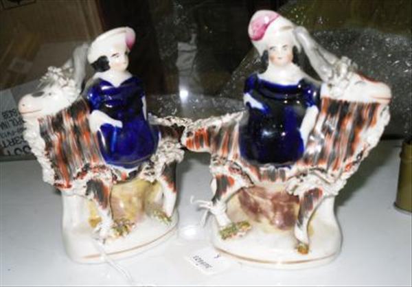 Appraisal: A pair of Staffordshire figures of girls on goats