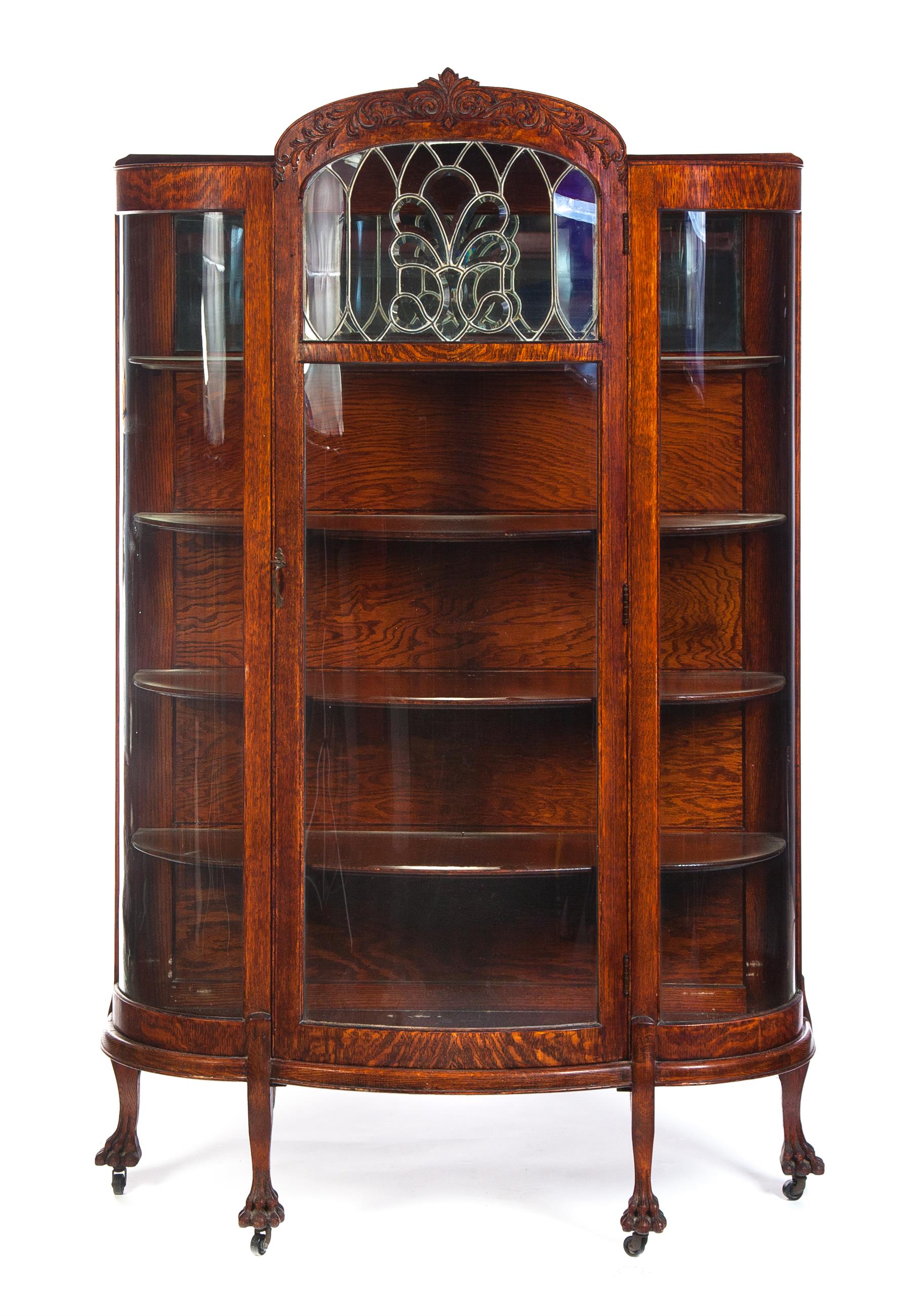 Appraisal: CURVED GLASS CHINA CABINET WITH LEADED GLASS PANEL American ca