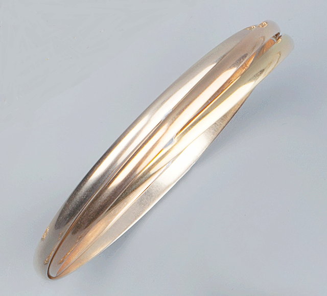 Appraisal: AN CT GOLD TRINITY BANGLE BY CARTIER composed of three