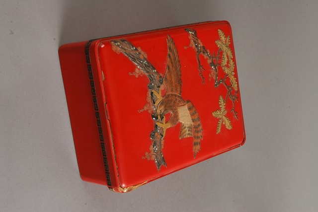 Appraisal: Okinawa Shikki Co oblong cover with applied colored ivory eagle