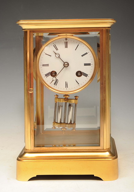 Appraisal: A FRENCH BRASS FOUR GLASS MANTEL CLOCK the movement striking