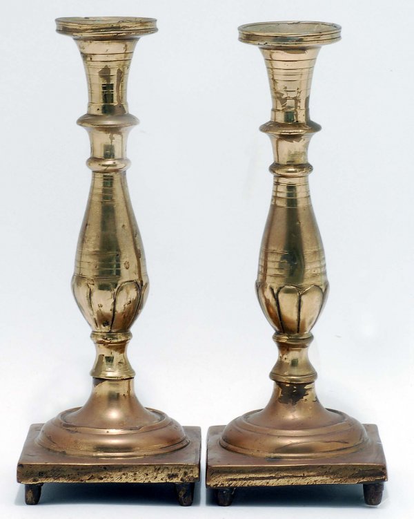 Appraisal: A pair of heavy brass candlesticks Two part Flared rims