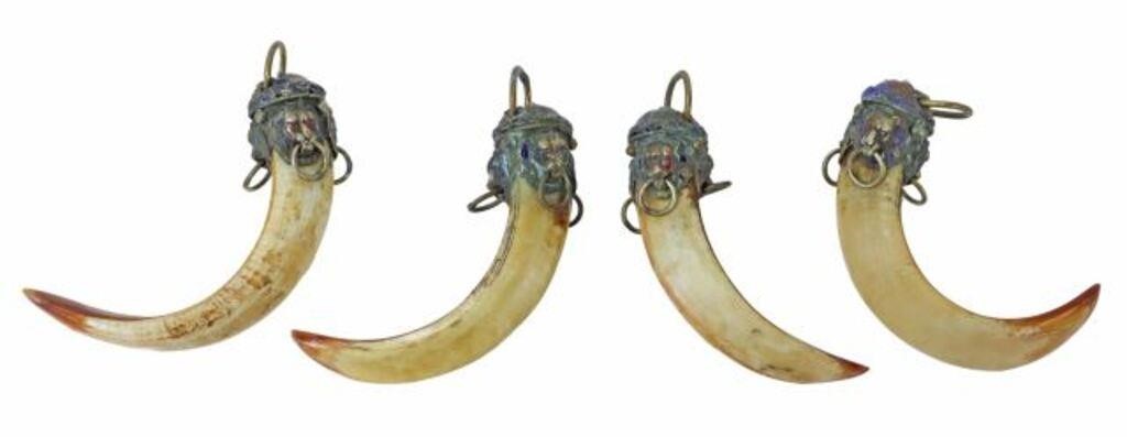 Appraisal: lot of Boar's tusk pendants likely Tibetan having polychrome painted