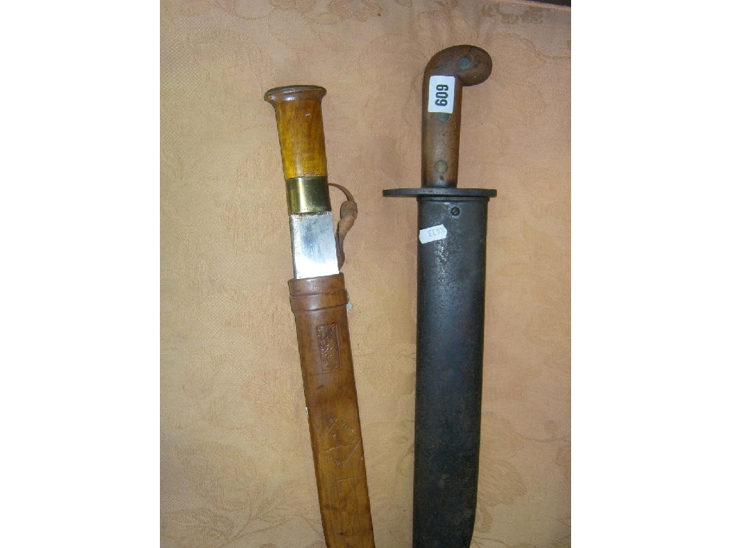 Appraisal: A machete with steel scabbard and teak wood handle further