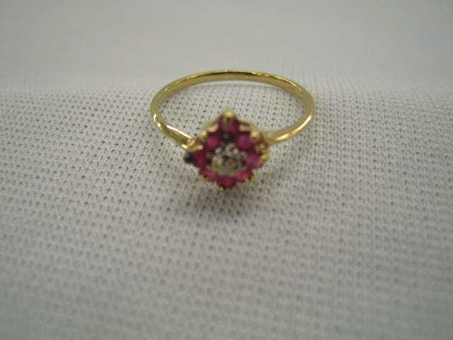 Appraisal: Ruby Diamond Ring rubies and small diamond forming a flower