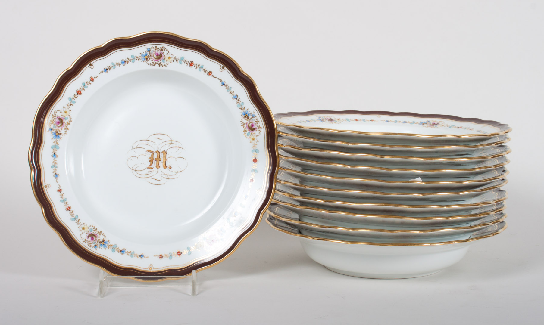 Appraisal: Meissen porcelain soup bowls each bowl with chocolate border floral