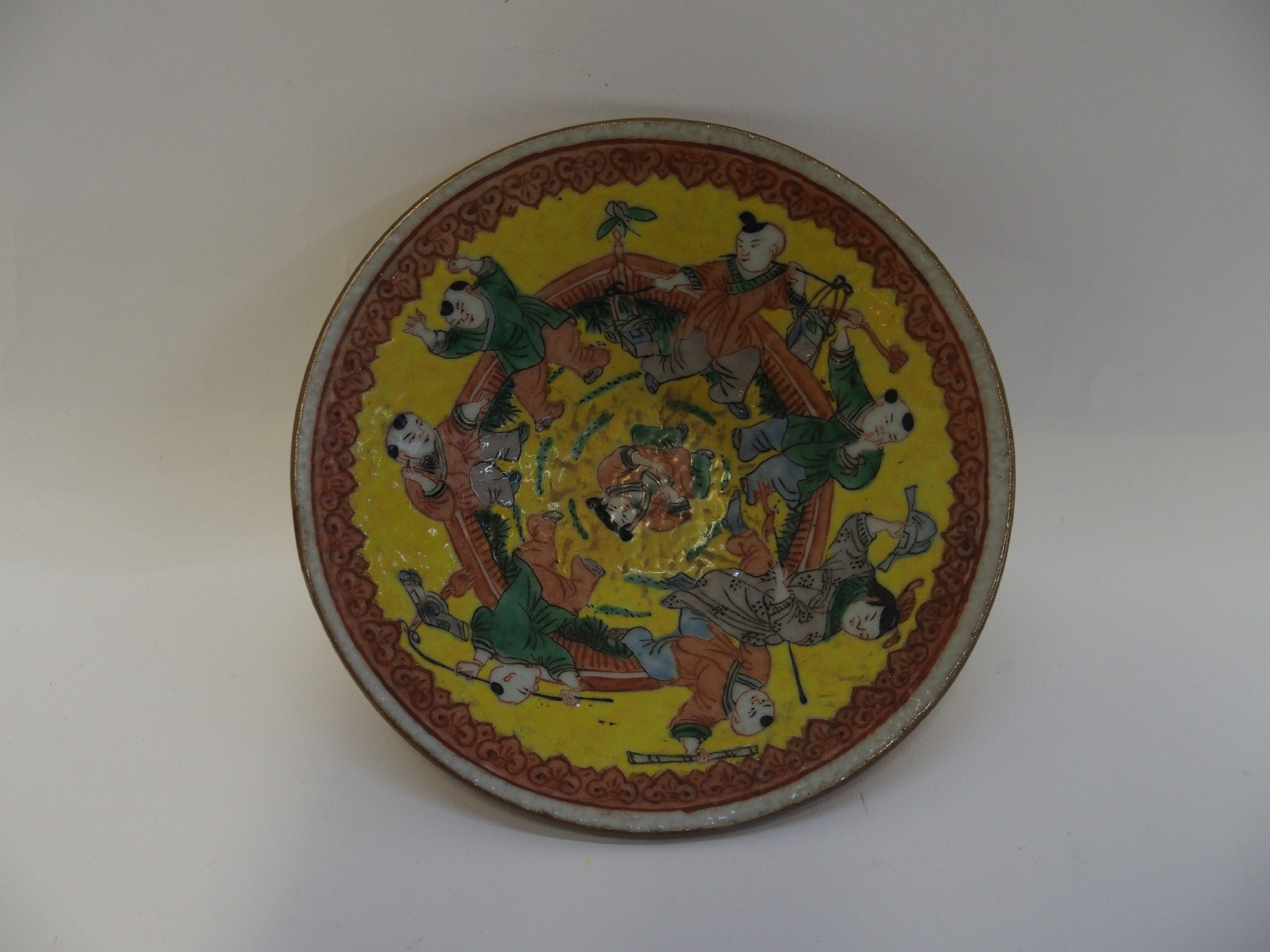 Appraisal: Chinese dish decorated with figures of boys on a yellow