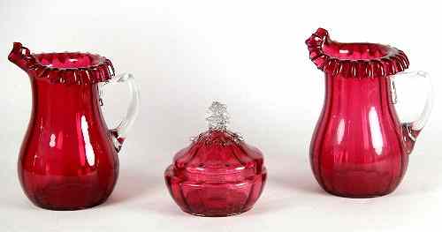 Appraisal: A pair of Stourbridge cranberry glass jugs cm and a