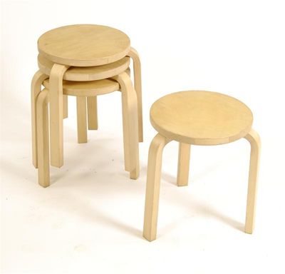 Appraisal: A set of four Artek bentply stacking stool tables designed