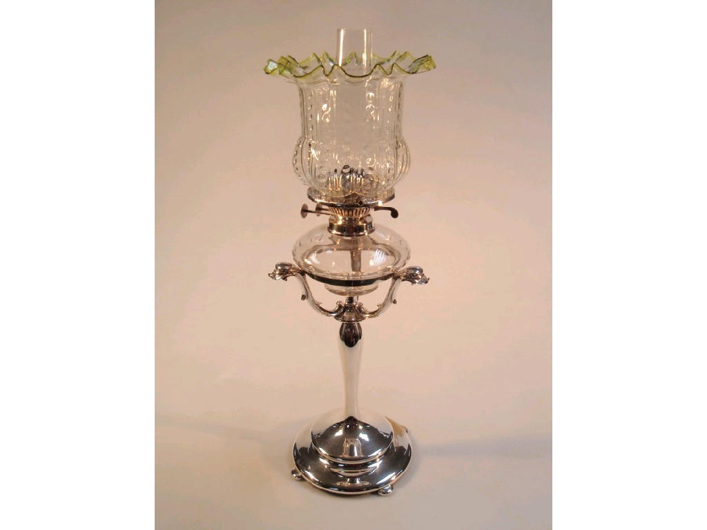 Appraisal: A fine silver plated oil lamp with moulded glass shade