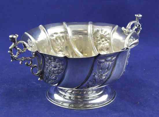 Appraisal: A late Victorian spiral fluted silver two handled bowl embossed