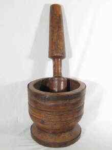 Appraisal: A large African pestle and mortar the pestle rough carved