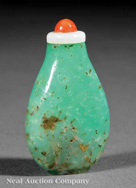 Appraisal: A Chinese Carved Emerald Green Quartz or Jadeite Snuff Bottle