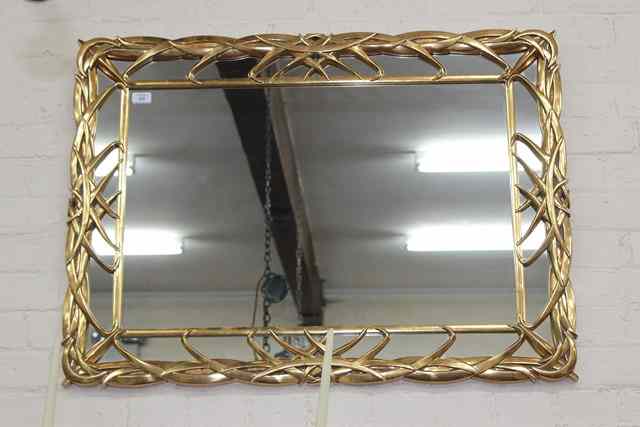 Appraisal: A GILT RECTANGULAR WALL MIRROR with leaf moulded frame wide