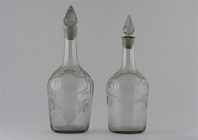 Appraisal: Two glass decanters with faceted stoppers one engraved with 'Beer'