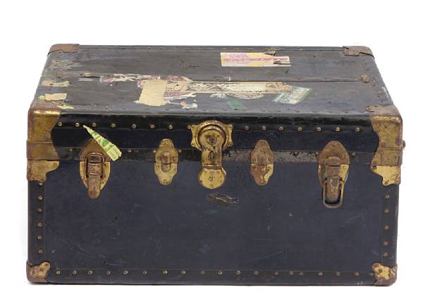 Appraisal: A black metal trunk with applied labels circa locked together