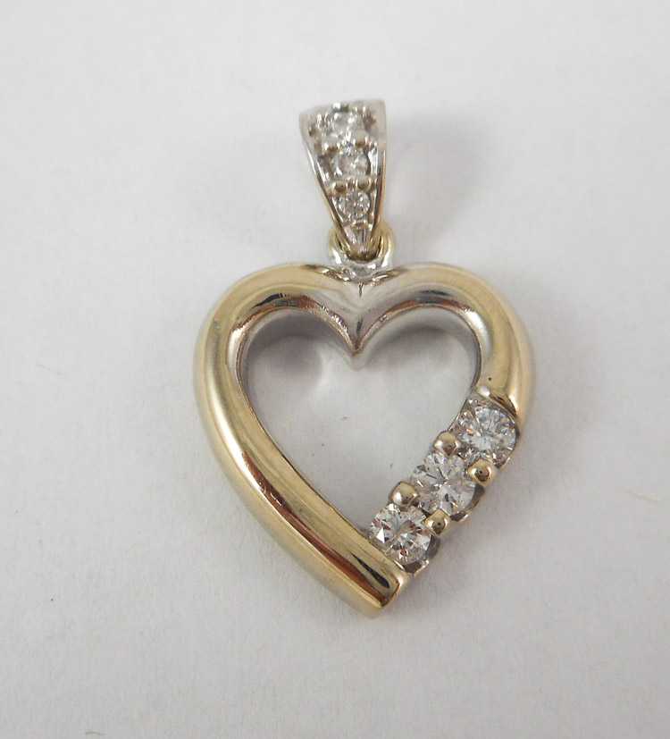 Appraisal: DIAMOND AND FOURTEEN KARAT WHITE GOLD PENDANT The open heart