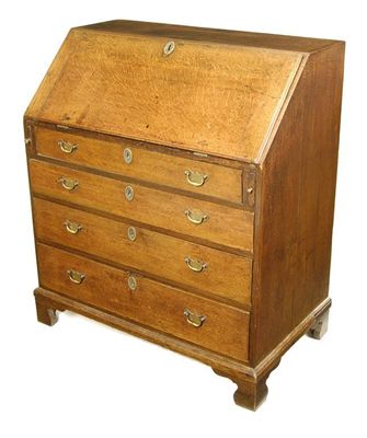 Appraisal: A George III oak bureau the hinged fall to a