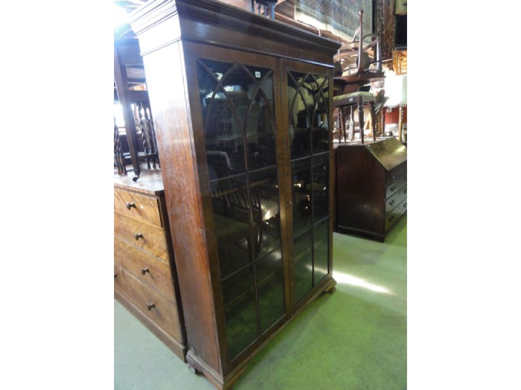 Appraisal: A th century mahogany bookcase with dentil moulded cornice over