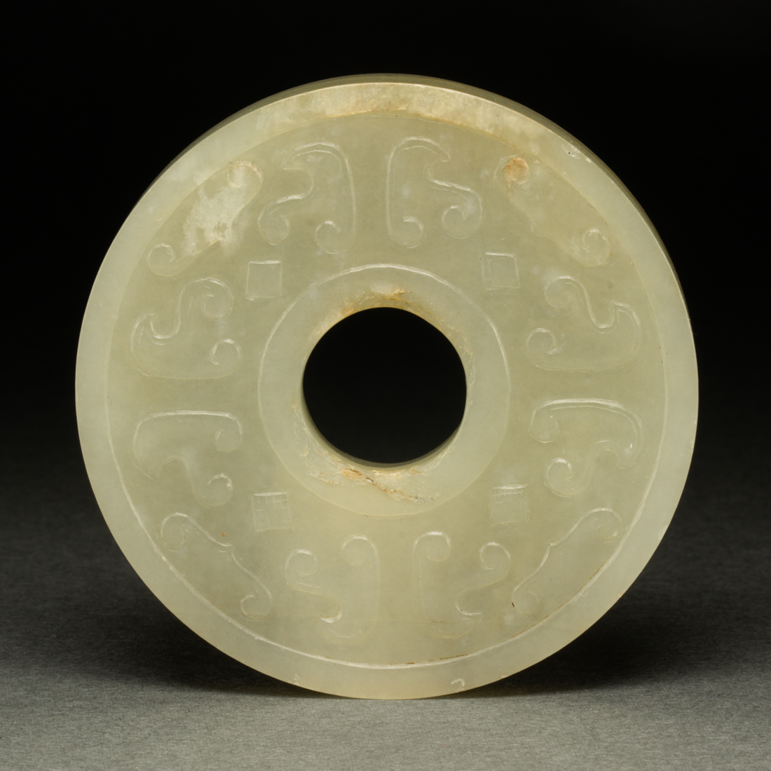 Appraisal: CHINESE CELADON JADE BI DISC Chinese celadon jade bi disc