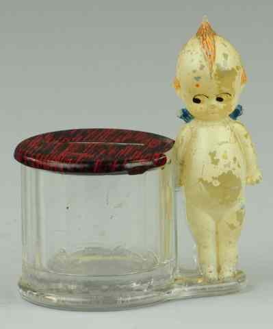 Appraisal: KEWPIE AT BARREL GLASS STILL BANK Borgfeldt Co tin coin