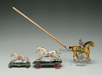 Appraisal: Three tin horse toys two white horses with orange saddle