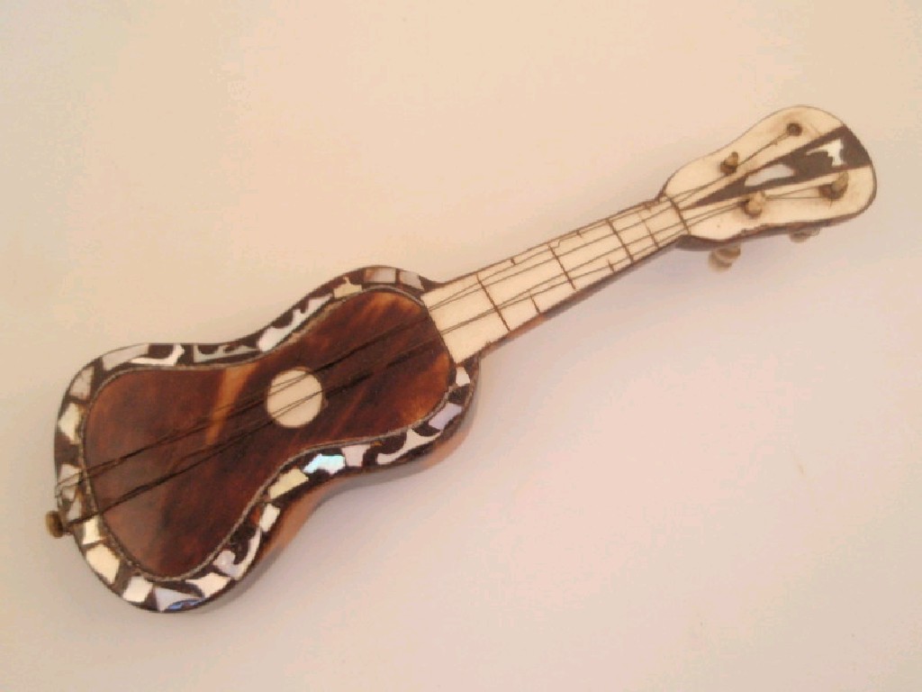 Appraisal: A miniature tortoiseshell covered model of a guitar