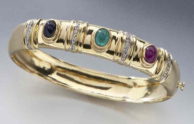 Appraisal: K diamond ruby emerald and sapphire banglebracelet featuring one oval