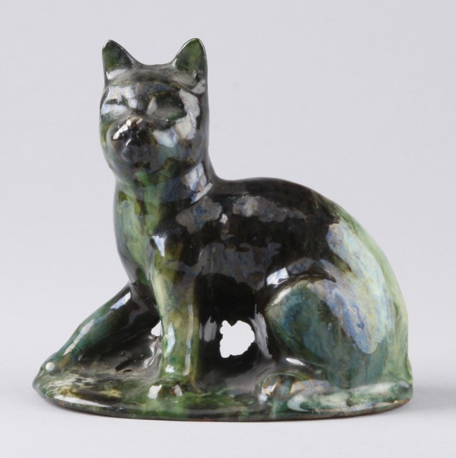 Appraisal: Redware cat features green and brown stripe glaze marked on