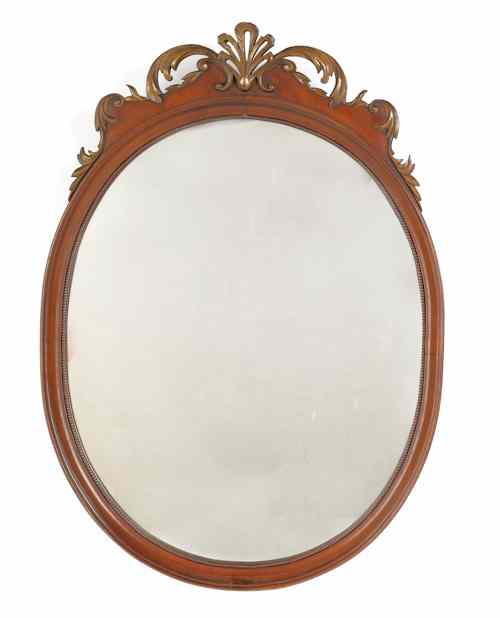 Appraisal: Mahogany oval mirror th c with a carved crest h