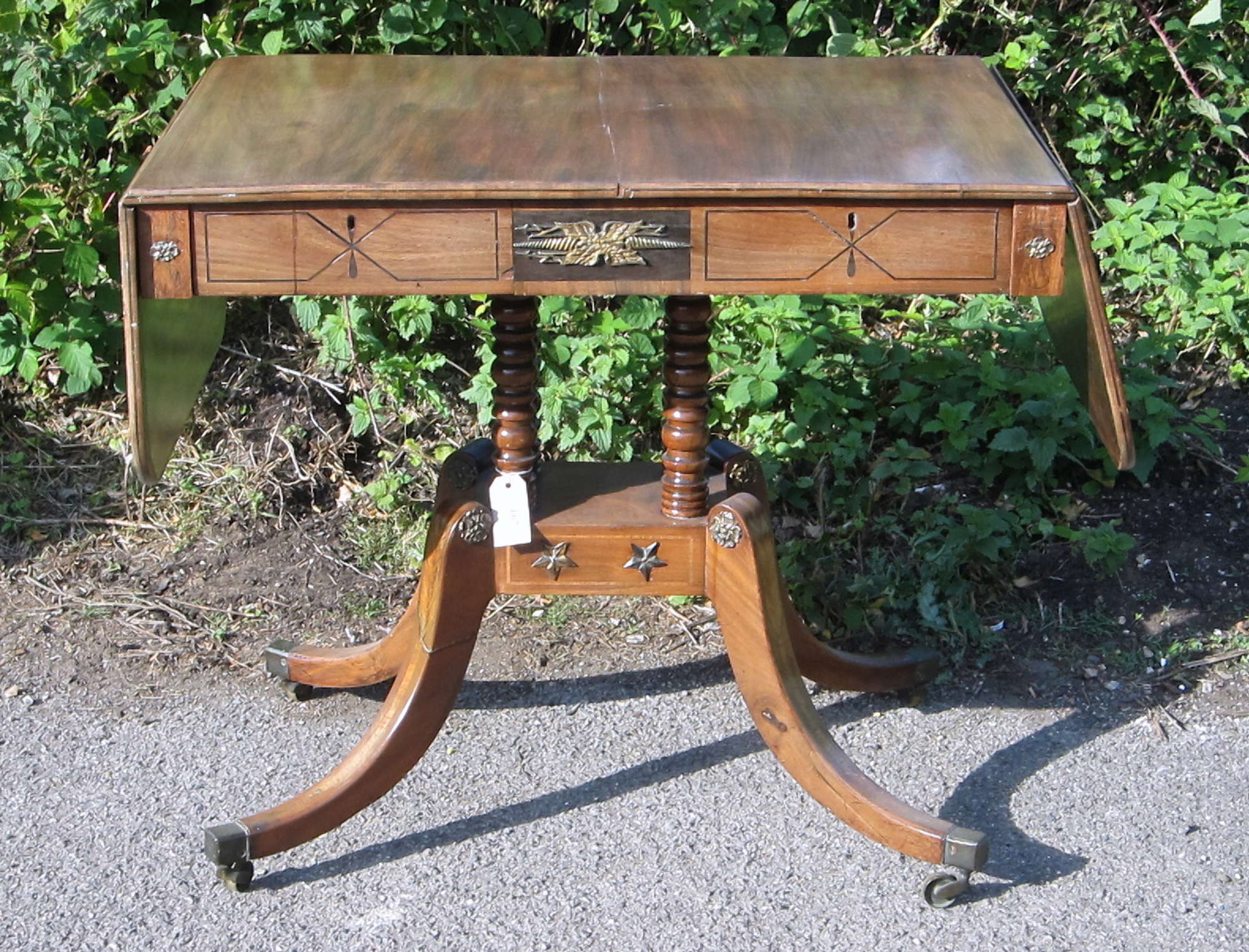 Appraisal: Mahogany and cross banded sofa table on four turned support