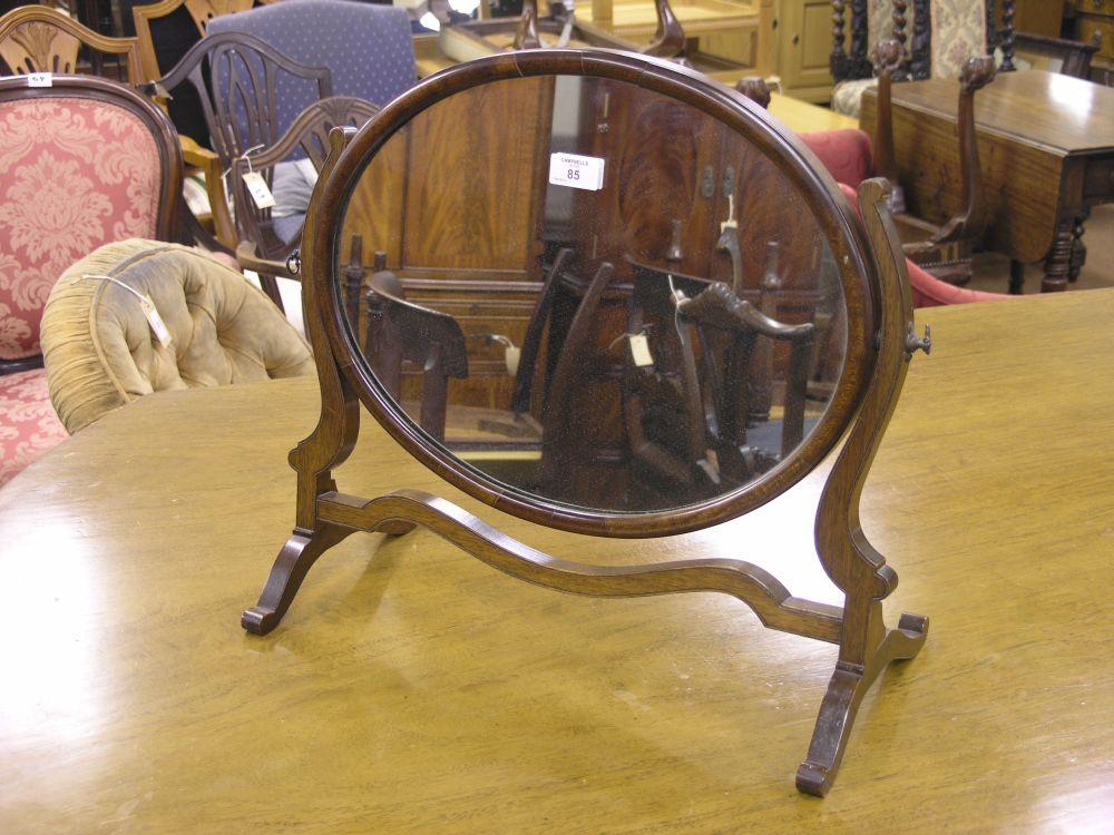 Appraisal: A reproduction mahogany toilet mirror with oval plate