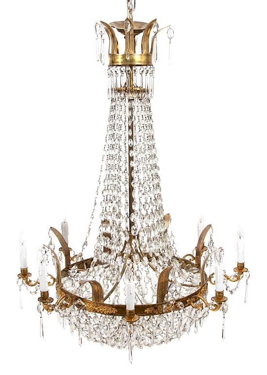 Appraisal: A Regency Style Gilt Metal and Glass Swag Tiered Chandelier