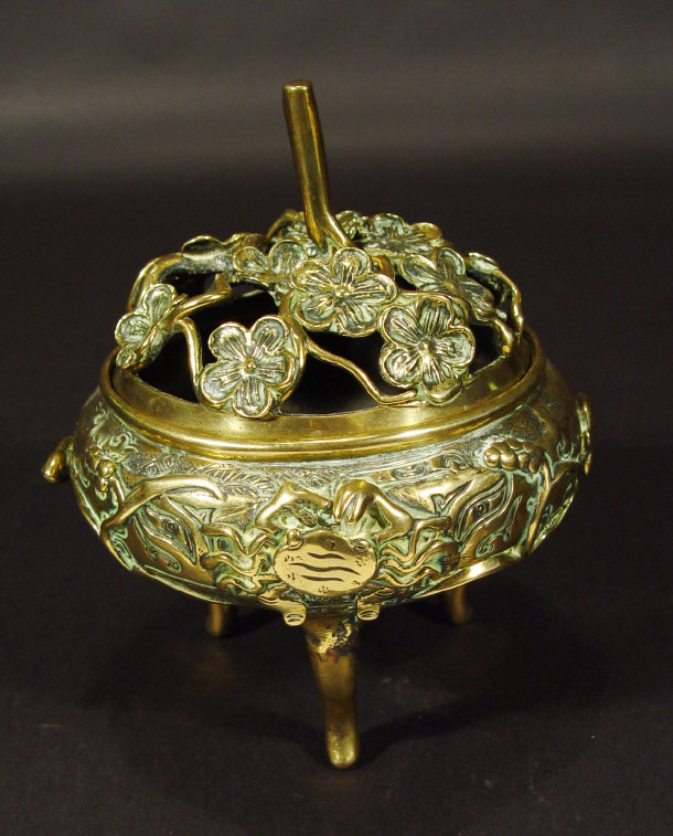 Appraisal: Oriental brass three footed pot and cover the lid cast