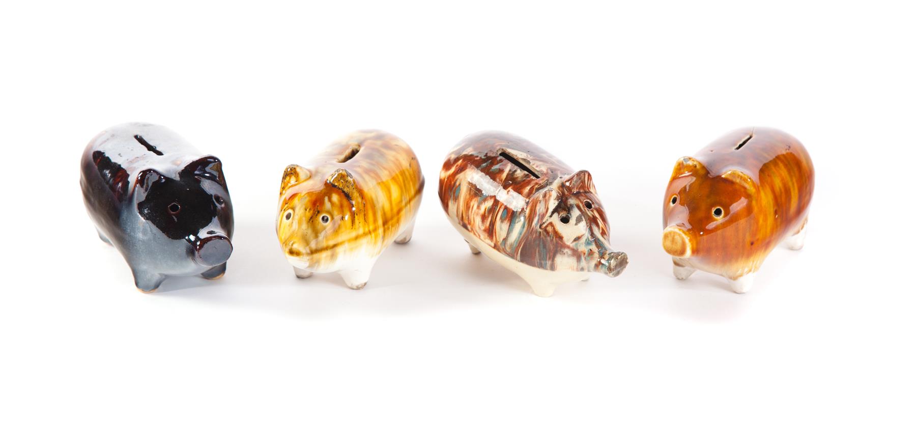 Appraisal: FOUR AMERICAN POTTERY PIGGY BANKS Second half- th century Yellow