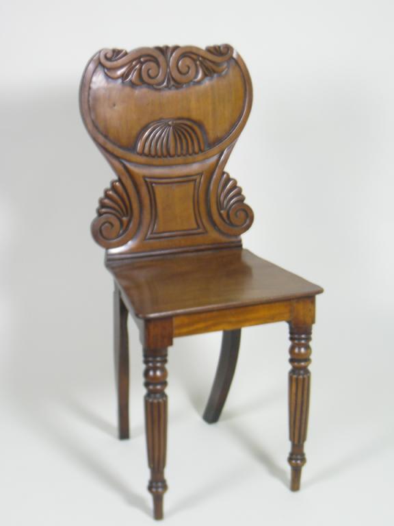 Appraisal: A Regency mahogany Hall Chair with scroll carved back solid